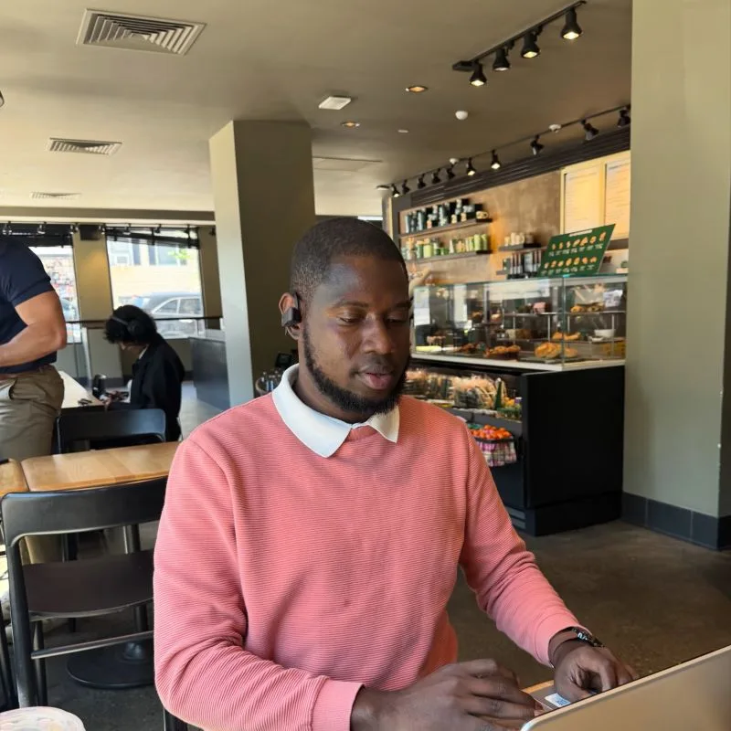 Jahmone working on his laptop in a coffee shop